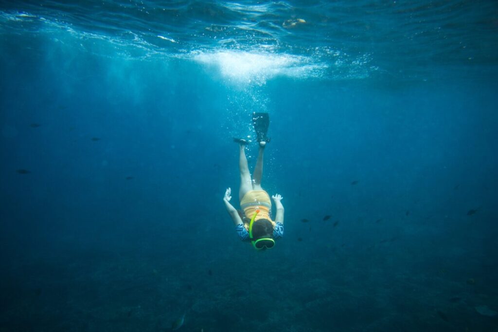 underwater-photo-of-woman-in-fins-diving-mask-and-snorkel-diving-alone-in-ocean.jpg